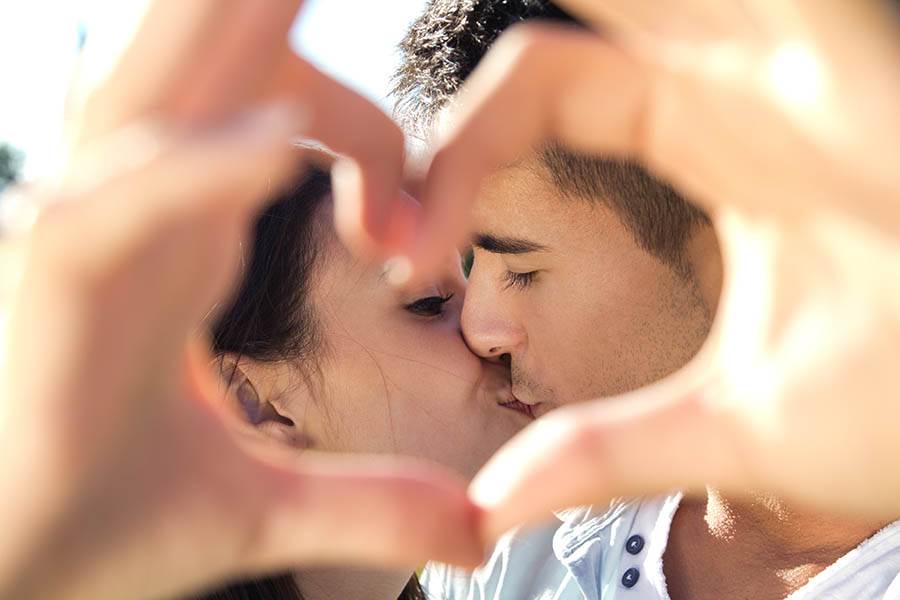 Couple making heart hands